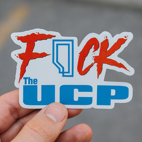 Sticker with red and blue text held by a hand against a blurred background