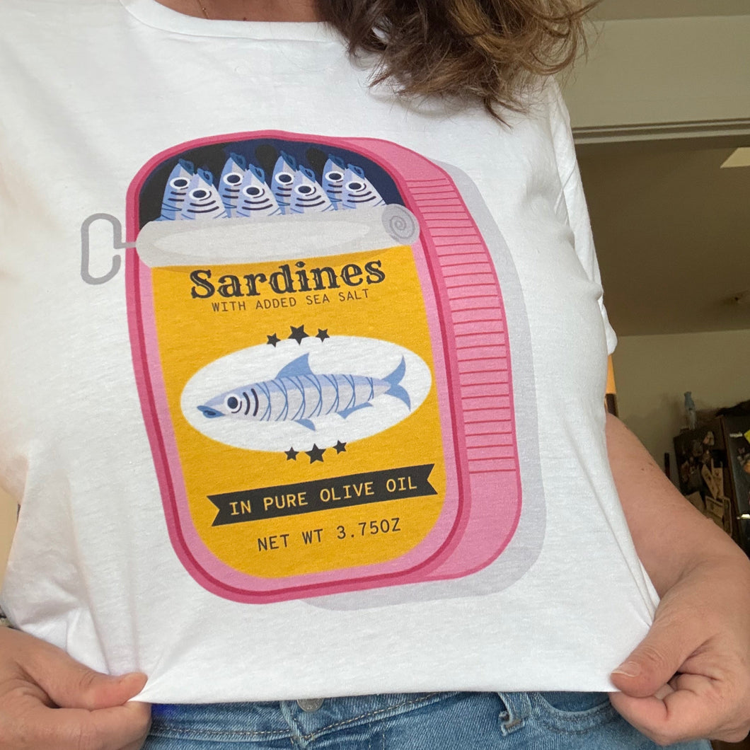 Person wearing a white t-shirt with a sardine can graphic design.