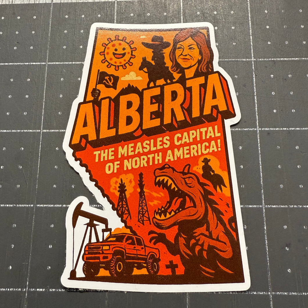 Sticker of Alberta's shape with graphics and text on a cutting mat