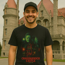 Man wearing a black t-shirt with a castle design in front of Craigdarroch Castle.