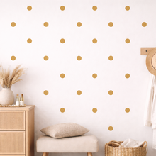 Room interior with wooden dresser, mirror, and polka dot wall design.
