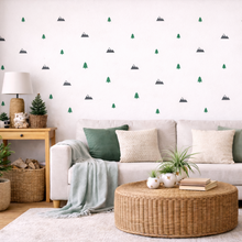 Living room with a white sofa, wooden coffee table, and decorative wall stickers.