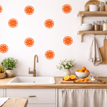 Kitchen with orange-themed wall decals, wooden shelves, and a sink.
