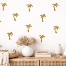 Decorative palm tree wall decals on a white wall with a wooden console table and decorative items.
