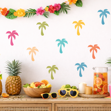 Tropical-themed party setup with fruit, drinks, and decorative elements on a wall.
