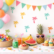 Colorful tropical-themed party setup with balloons, pineapple decorations, and snacks.