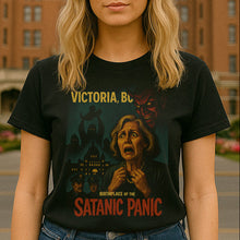 Person wearing a t-shirt with a graphic design in front of a large building