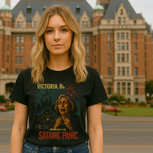 Person wearing a t-shirt with a graphic design in front of a large building