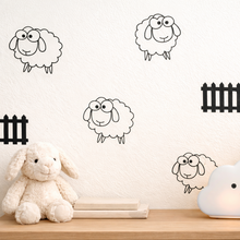 Sheep and fence wall decals with a plush toy and night light on a shelf.