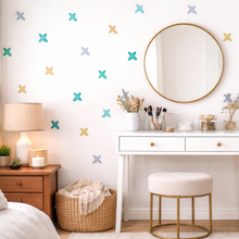 Nursery room with round mirror, white dresser, and decorative wall stickers.